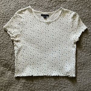 white shirt with little blue and yellow flowers